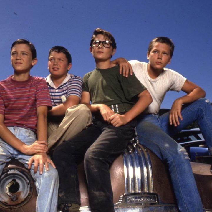 Four boys sit on the hood of a car in the film, "Stand By Me."