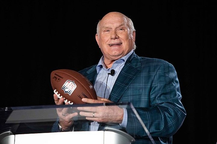 Terry Bradshaw holds a football.