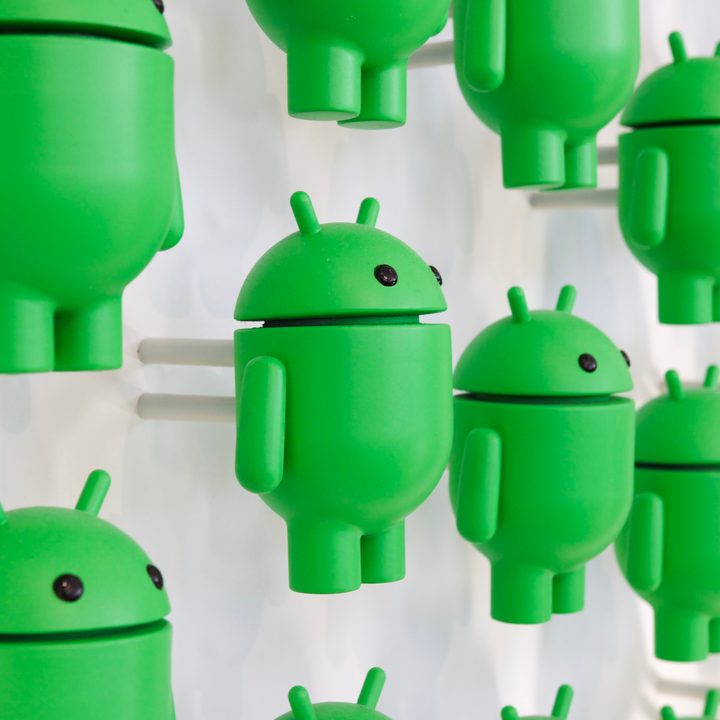 A photo of many Android figurines on a white wall.