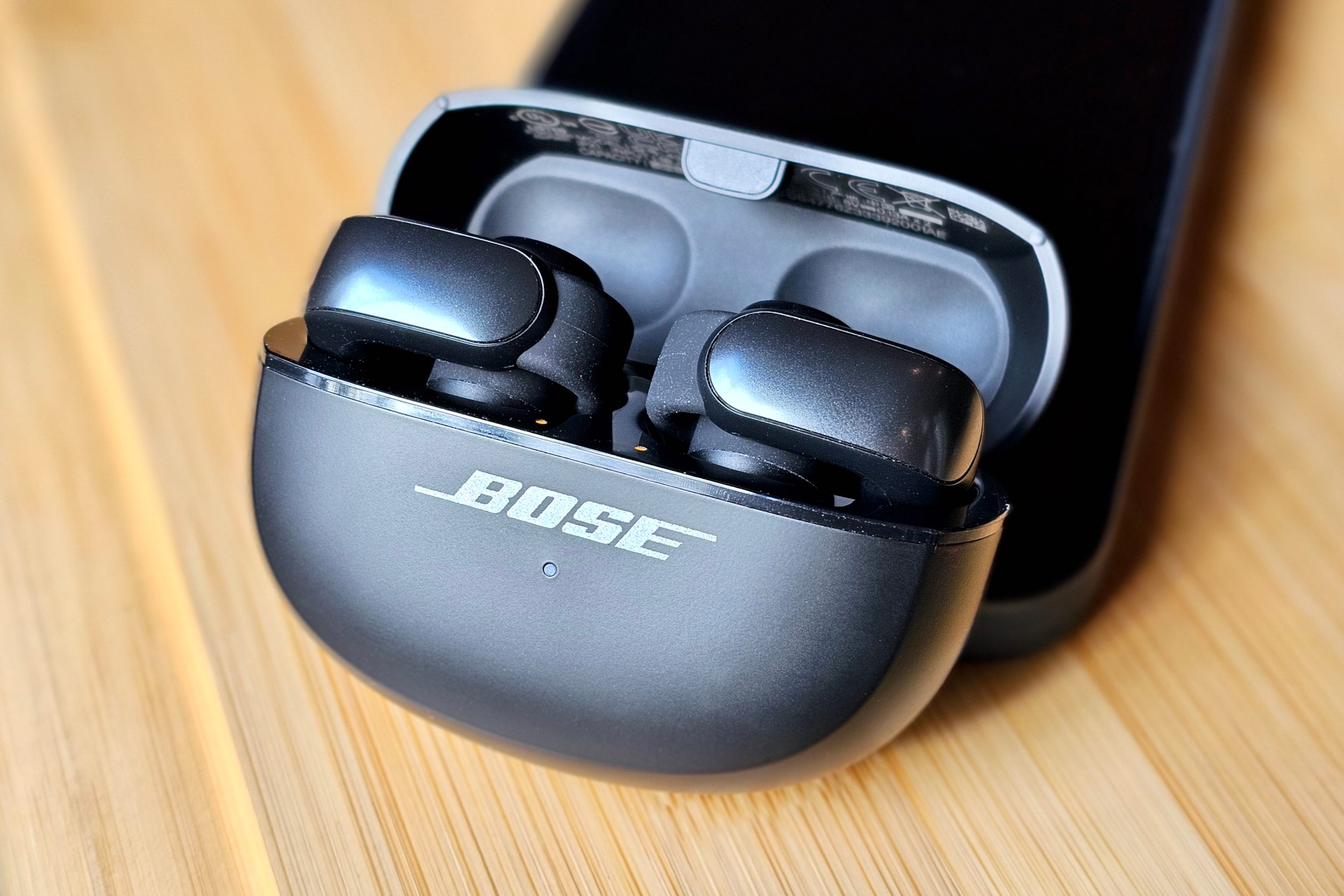 Bose Ultra Open Earbuds inside their charging case.