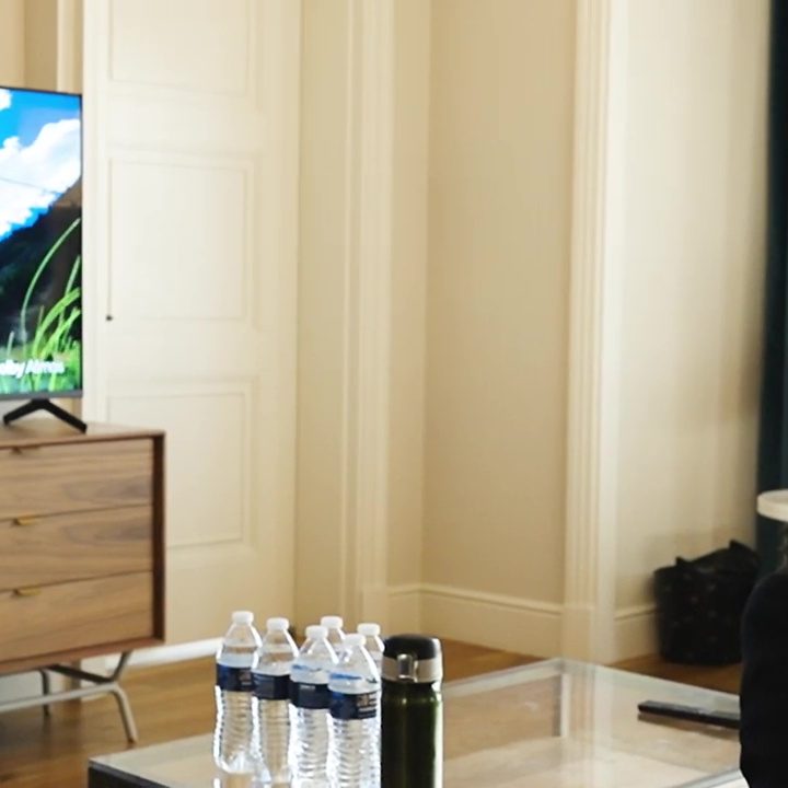 A man watches a fly fishing video while experiencing Dolby Atmos FlexConnect.