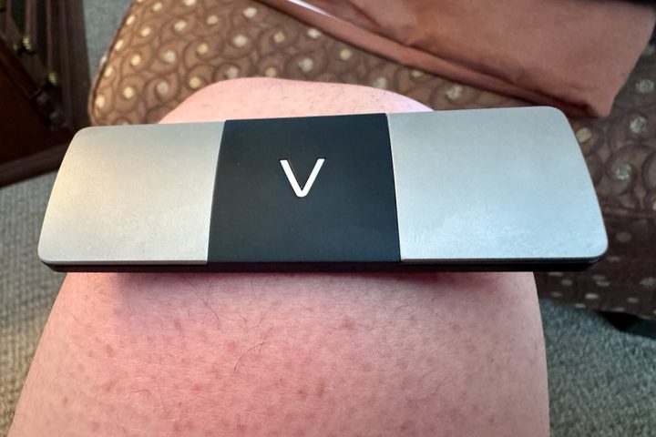 A KardiaMobile 6L on a knee for EKG testing.