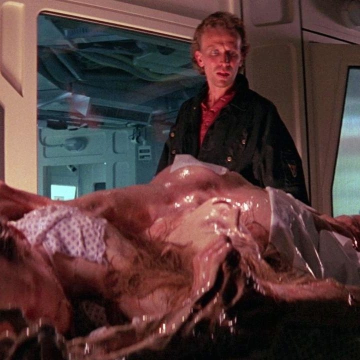 Two men look at a monster in Leviathan.