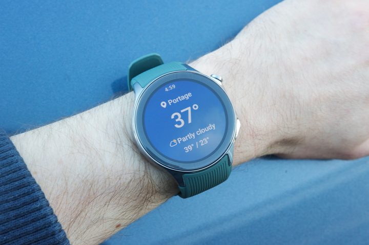 The OnePlus Watch 2 on someone's wrist, showing the weather app.