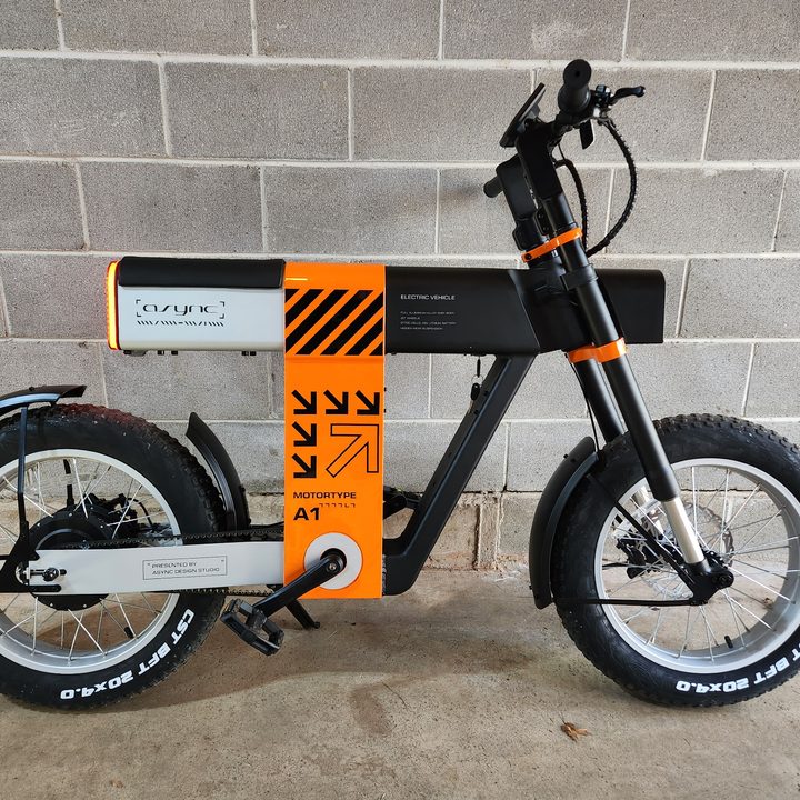 Async A1 Pro e-bike right profile with a concrete block background.