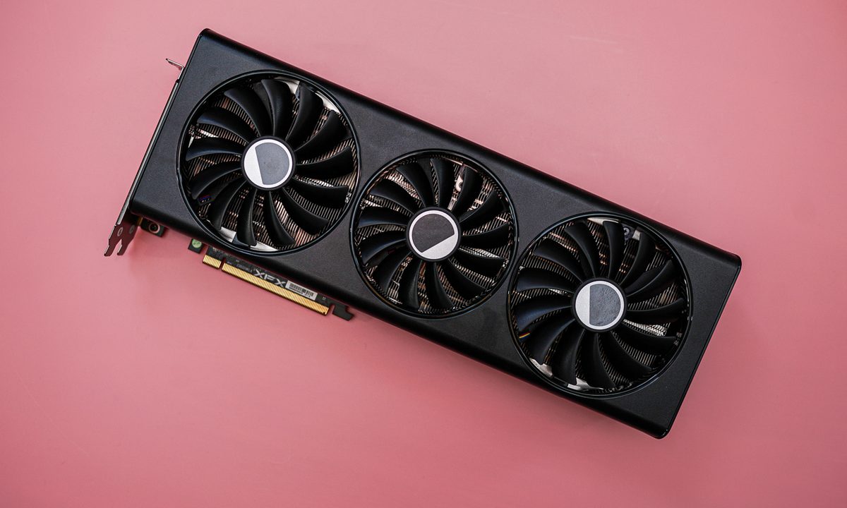 The AMD RX 7900 graphics card on a pink background.