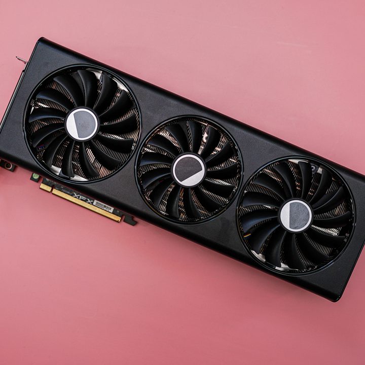The AMD RX 7900 graphics card on a pink background.