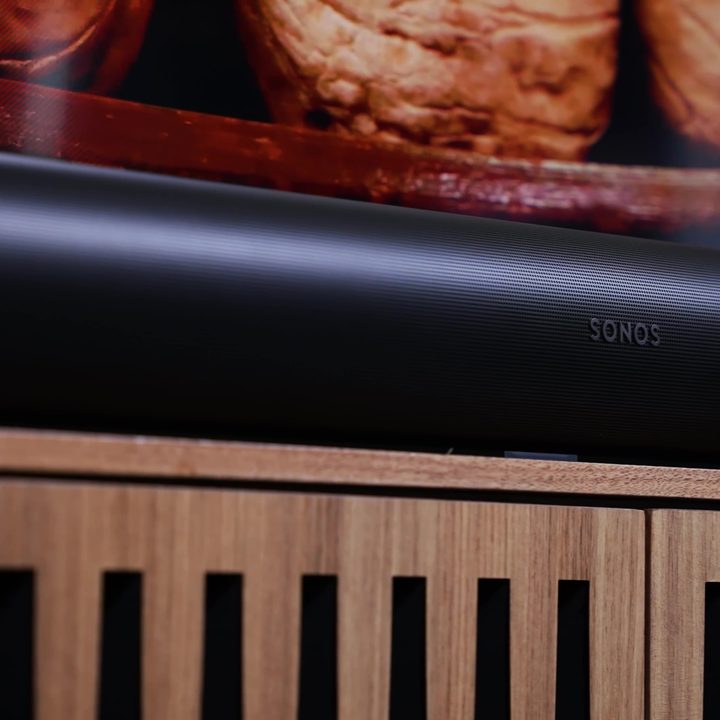 A closeup on a Sonos Src Soundbar on a media stand.