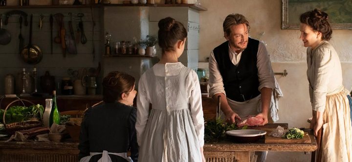 Four people cook in a kitchen in The Taste of Things.