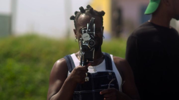 A man looks through camera.