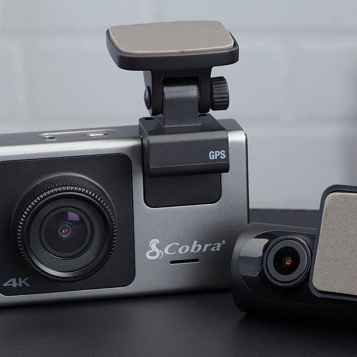 The Cobra SC 400D dash cam on a desk.