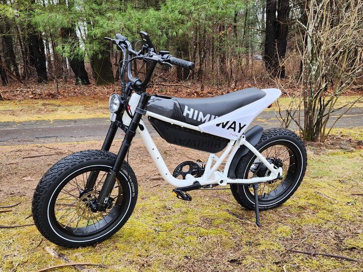 Himiway C5 e-bike left side front angled view parked on wet grass.