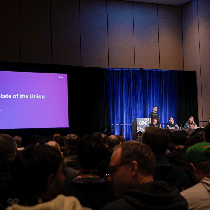 Microsoft presenters on stage at a GDC session.