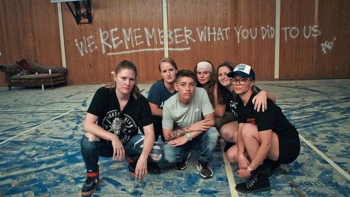 A group of teenagers on their knees in 'The Program.'