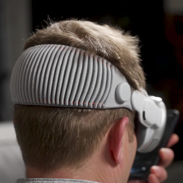 A man seen from the rear wearing an Apple Vision Pro headset.