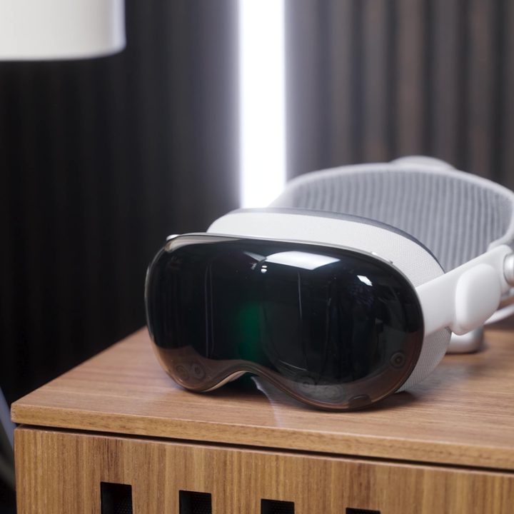 An Apple Vision Pro headset on a side table.