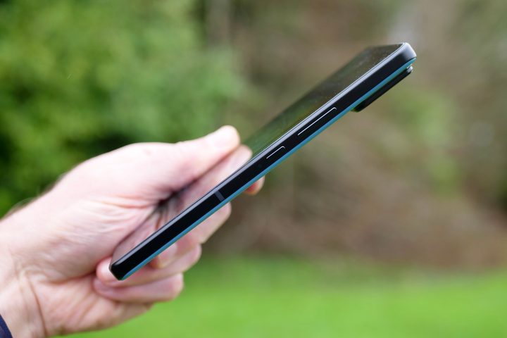 A person holding the Asus Zenfone 11 Ultra, showing the buttons on the side.
