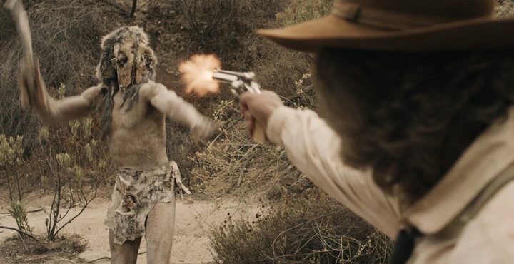 A man shoots a monster in Bone Tomahawk.