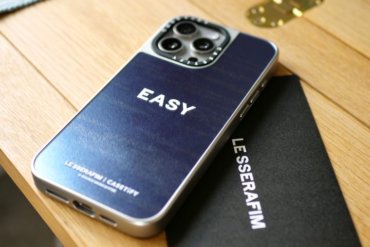An iPhone 15 Pro Max with a Casetify x Le Sserafim case.