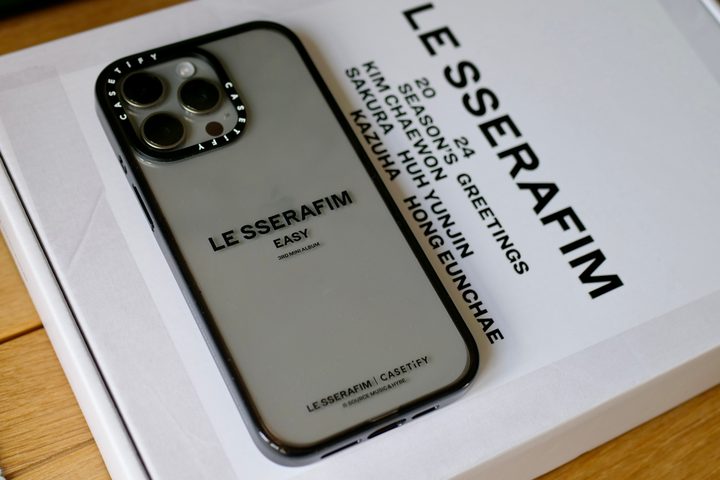 An iPhone 15 Pro Max with a Casetify x Le Sserafim case.