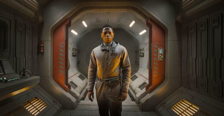 A man stands in a space ship hallway in Alien: Romulus.