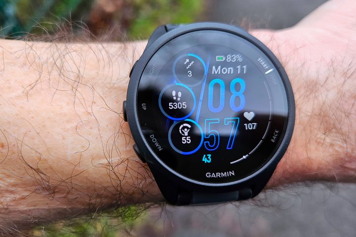 The Garmin Forerunner 165 Music worn on a wrist. The watchface is open.