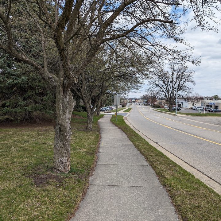 A photo of a sidewalk and a road outside, taken with the Google Pixel 8.