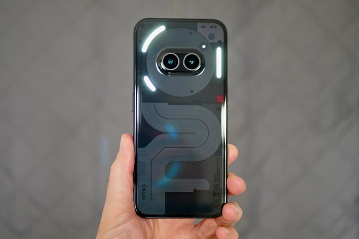 A person holding the Nothing Phone 2a, showing the Glyph Lights.