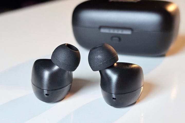 PSB Speakers M4U TWM earbuds in front of charging case.
