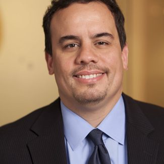 A headshot shows Ray Rodriguez in a suit.