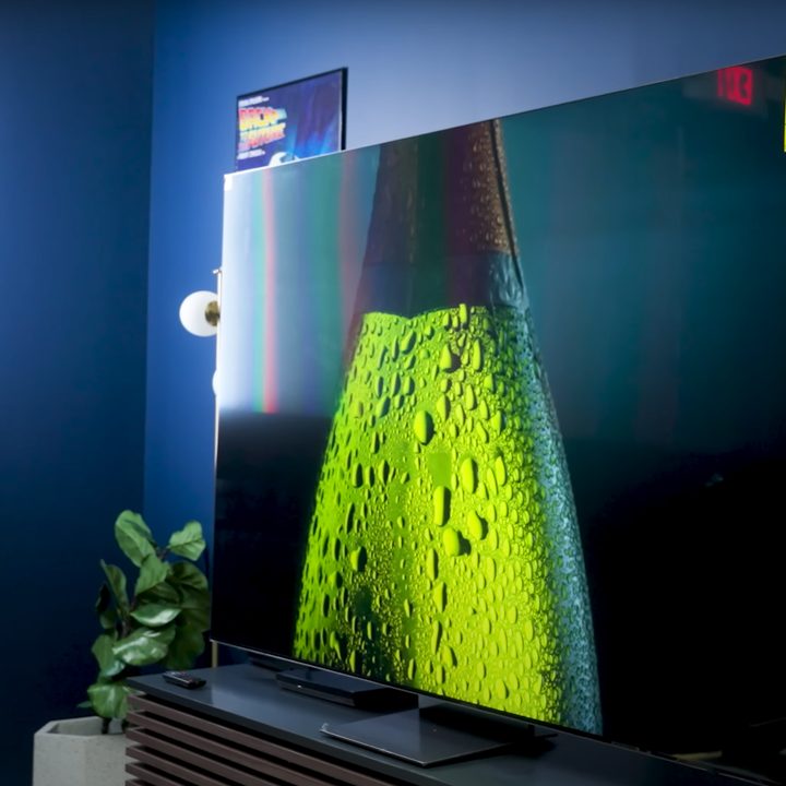 A vibrant green dew-covered object is shown on a Samsung QN900D.