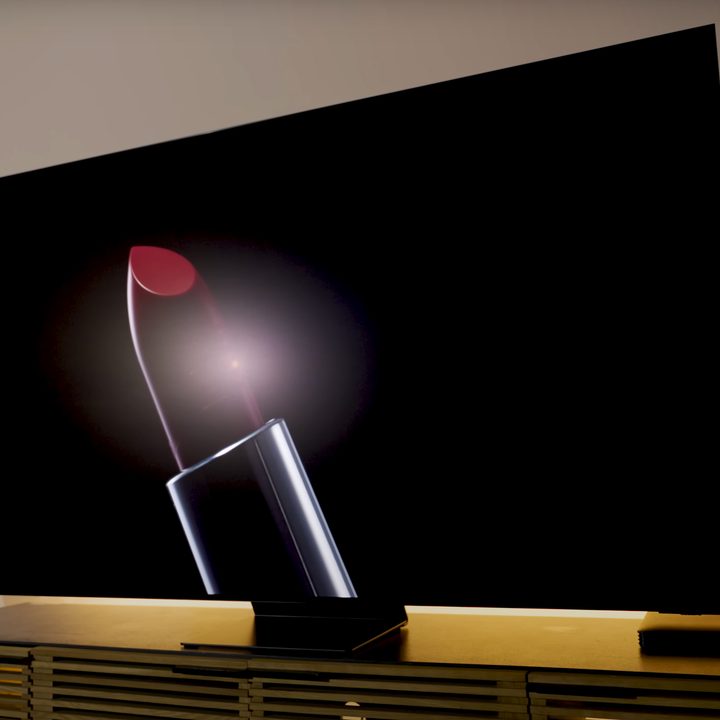 A backlit giant lipstick shown on a Samsung S95D OLED.