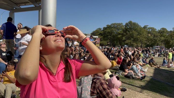 A person watches the annular solar eclipse of October 14, 2023, in Kerrville, Texas.
