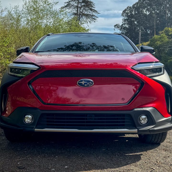 A front-end view of a red 2024 Subaru Solterra.