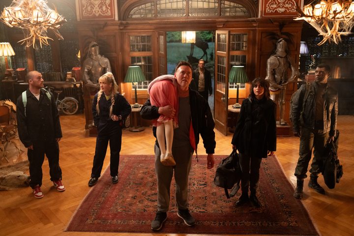 A group of criminals stand in a manor's entryway in Abigail.