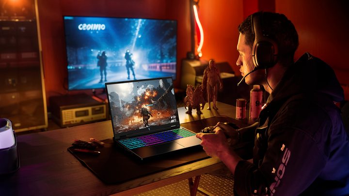 A person gaming on the new Acer Nitro 16 gaming laptop placed on a desk.