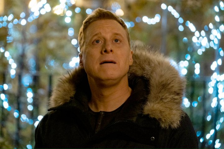 Alan Tudyk looks up and ponders in Resident Alien.