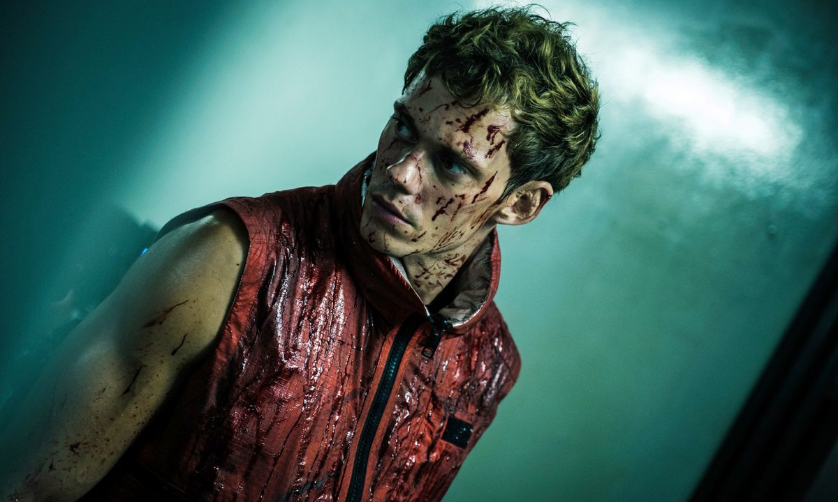 A man looks to his side in Boy Kills World.