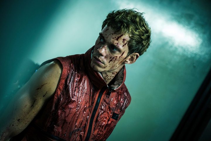 A man looks to his side in Boy Kills World.