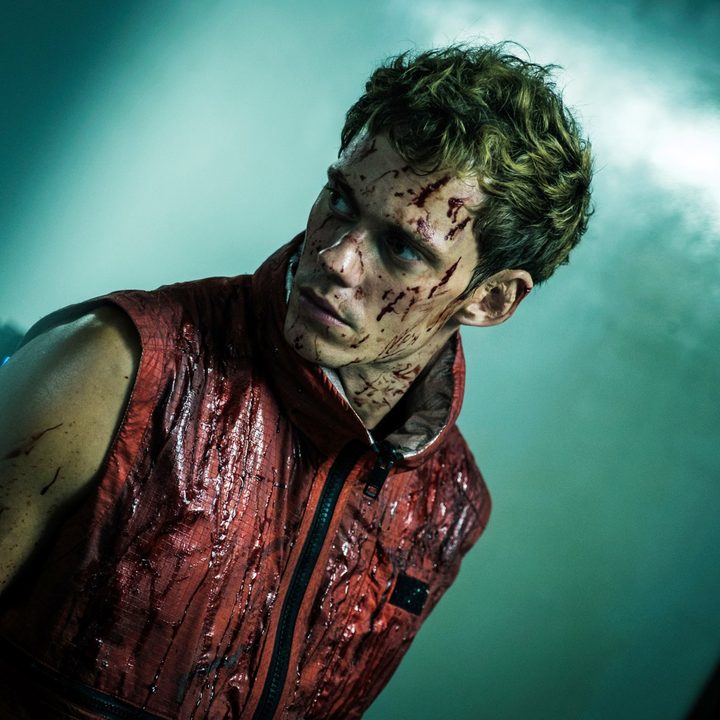 A man looks to his side in Boy Kills World.