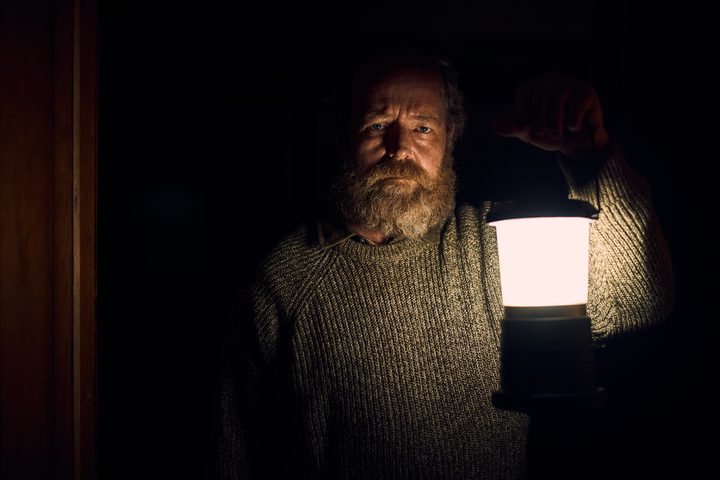 Brendan Rock holds a lantern in You'll Never Find Me.