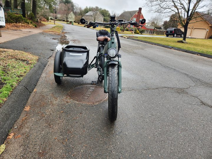 Front view of a MOD Easy Sidecar parked on the side of a public street.