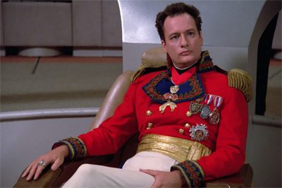 Q sitting in ‘The Next Generation.’