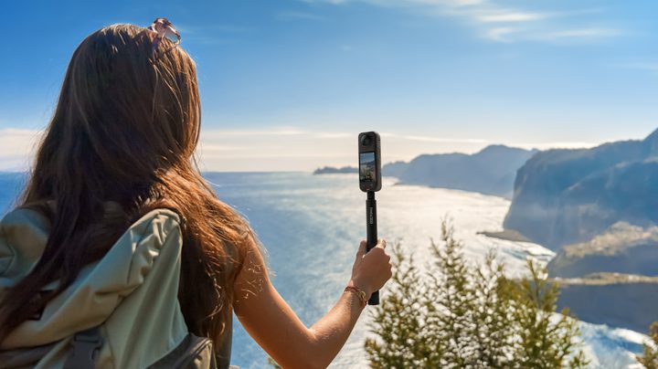 A person holding the Insta360 X4.