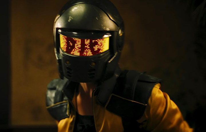 A female warrior wears a helmet that says, "Die."