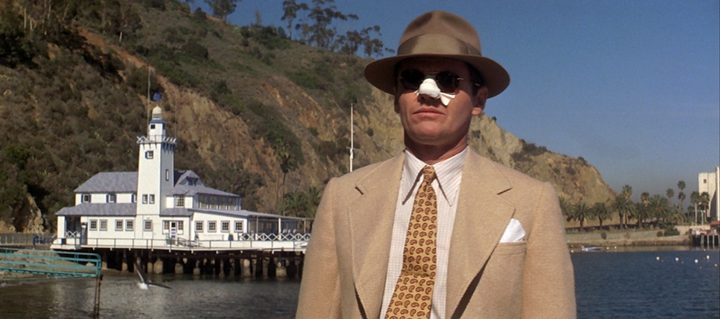 Jack Nicholson standing on a dock in the movie Chinatown (1974)