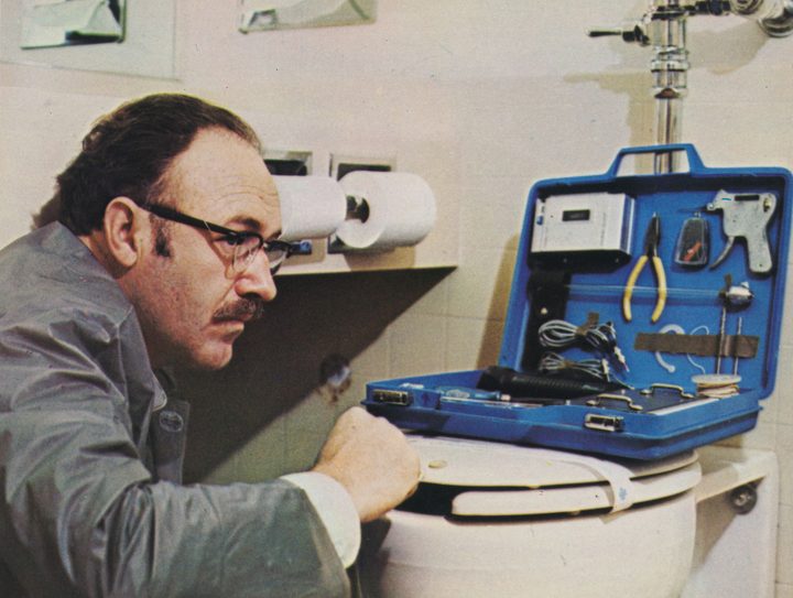 Gene Hackman opening up a toolbox on top of a toilet in The Conversation (1974)