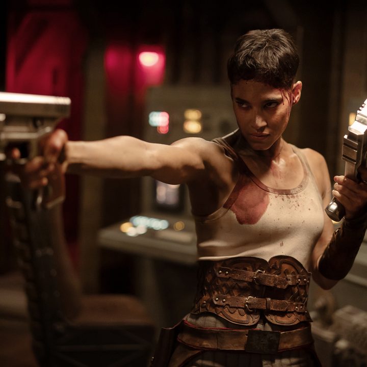 A woman points a gun and stares in "Rebel Moon: Part Two - The Scargiver."