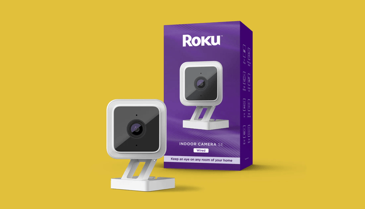 The Roku Smart Home Indoor Camera on colored background.