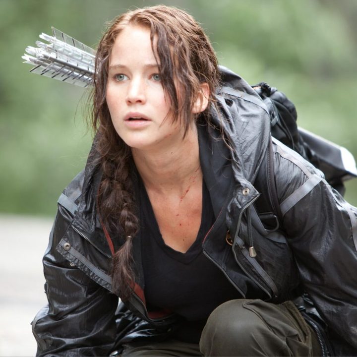 Jennifer Lawrence crouches to the ground in "The Hunger Games."